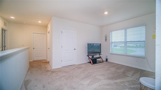 interior space featuring recessed lighting, visible vents, baseboards, and light colored carpet