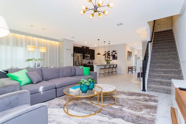 tiled living room featuring sink, a chandelier, and ornamental molding