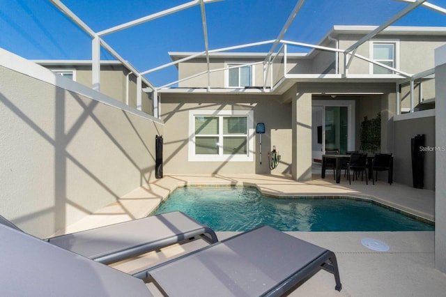 view of swimming pool featuring a lanai and a patio area