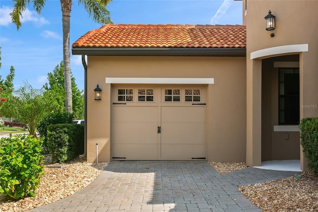 garage featuring decorative driveway