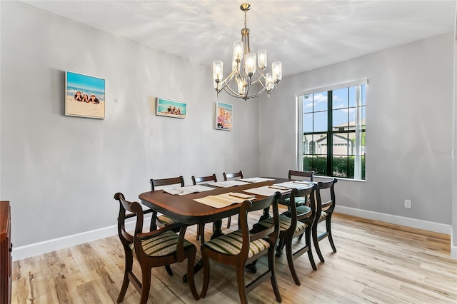 dining area featuring a notable chandelier and light hardwood / wood-style flooring