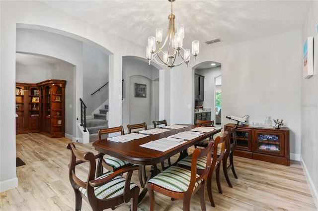 dining area with an inviting chandelier and light wood-type flooring