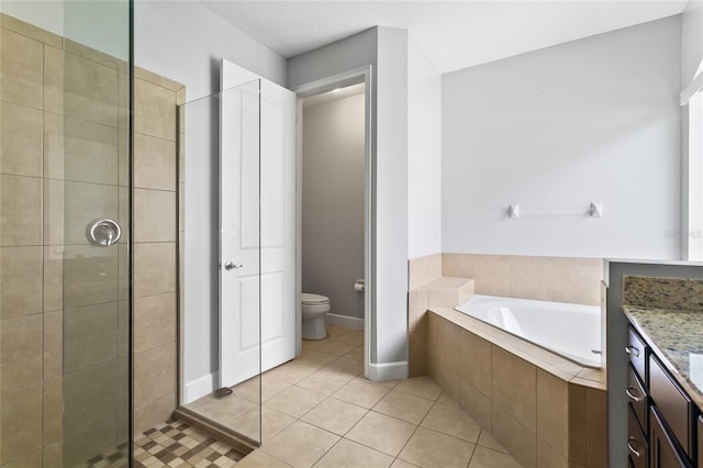 bathroom with toilet, vanity, a shower stall, a bath, and tile patterned floors