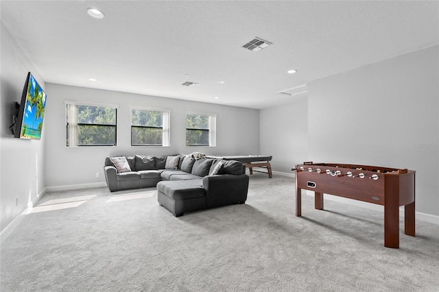 carpeted living room with baseboards, visible vents, and recessed lighting