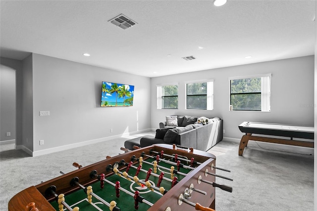 recreation room with a wealth of natural light, carpet flooring, and visible vents