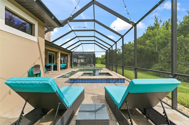 view of pool featuring a patio, an in ground hot tub, and a lanai