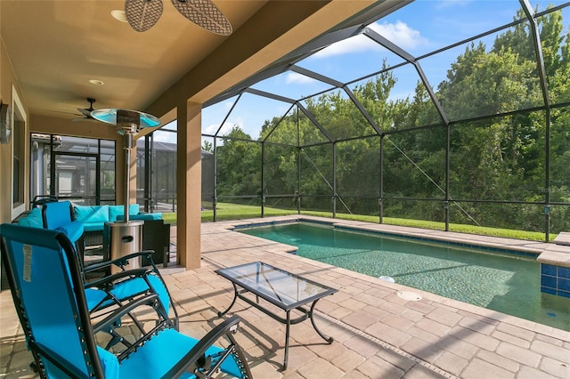 view of swimming pool featuring ceiling fan, glass enclosure, and a patio area