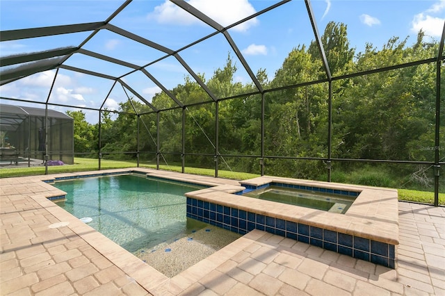 view of swimming pool with an in ground hot tub, glass enclosure, and a patio