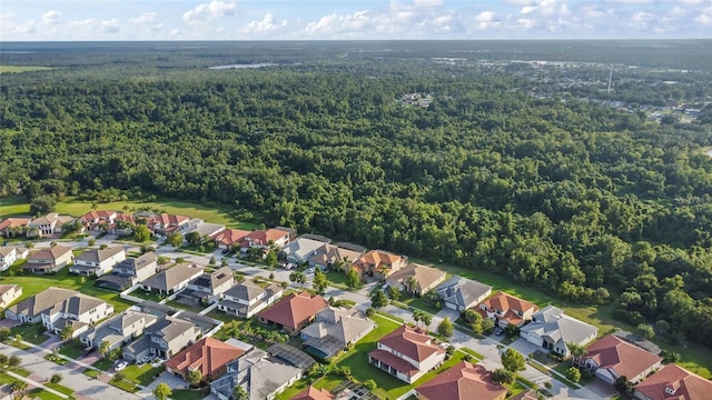 bird's eye view featuring a wooded view and a residential view