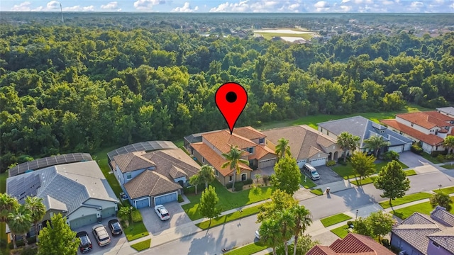 birds eye view of property featuring a residential view and a view of trees