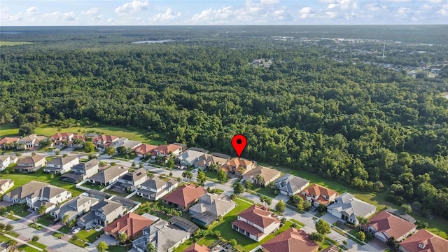 drone / aerial view with a residential view and a view of trees