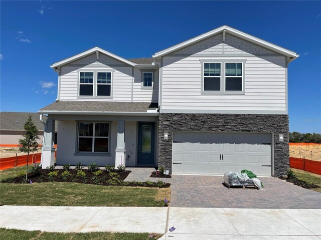 view of front of home with a garage and a front lawn