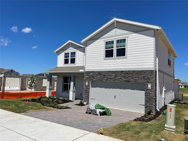 view of front of home with a garage and a front lawn