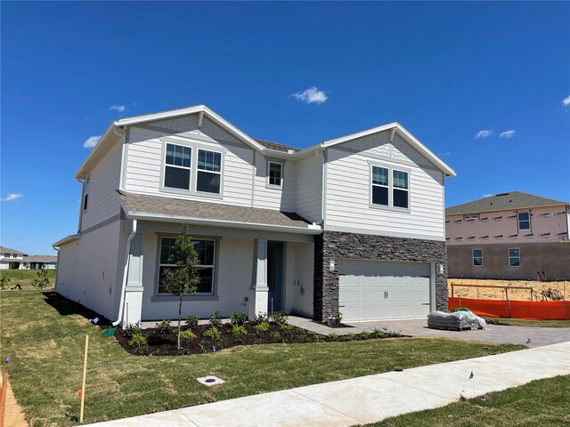 view of front of home with a garage and a front yard