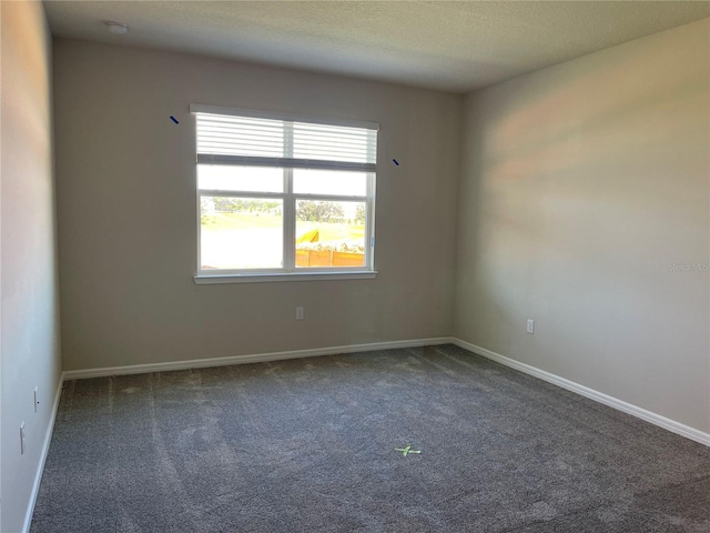 carpeted spare room with a textured ceiling