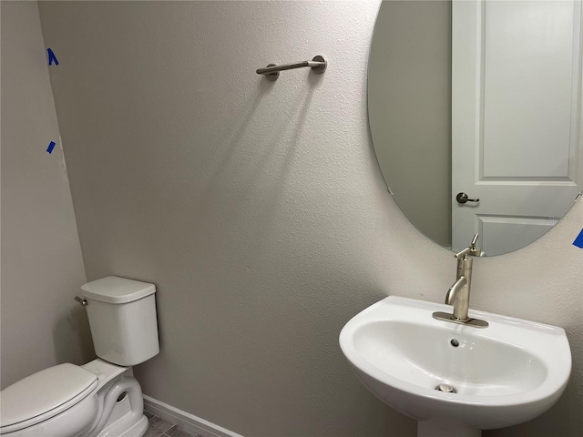 bathroom featuring sink and toilet