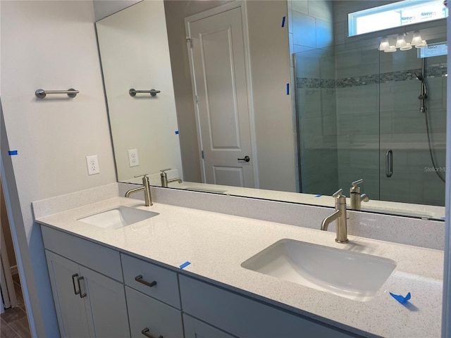 bathroom with vanity and a shower with door