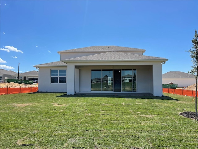 rear view of house with a yard