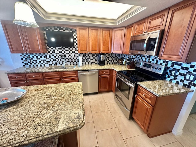 kitchen with appliances with stainless steel finishes, sink, ornamental molding, and decorative backsplash