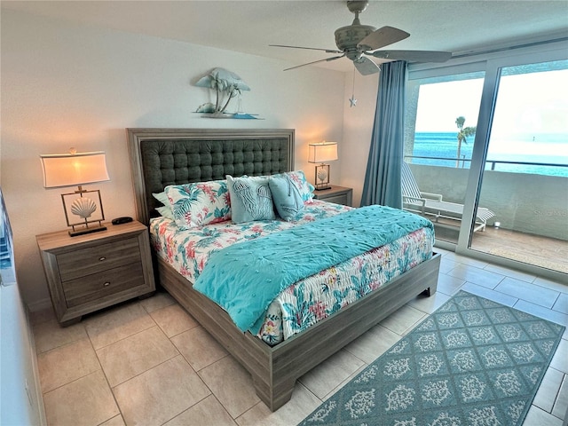 tiled bedroom featuring ceiling fan, a water view, and access to exterior