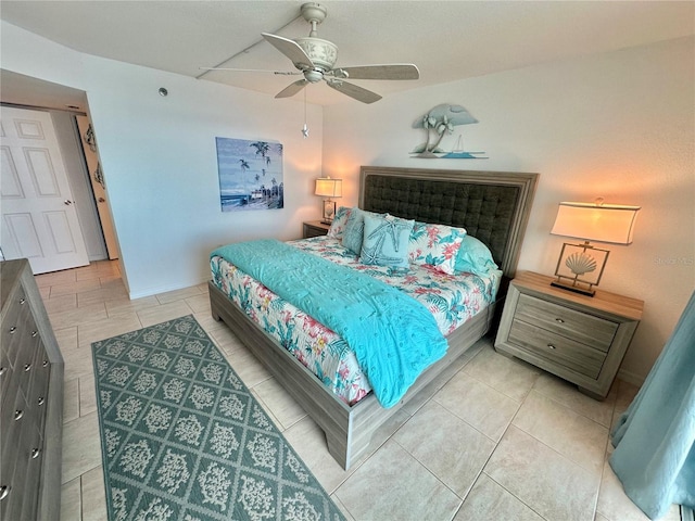 tiled bedroom with ceiling fan