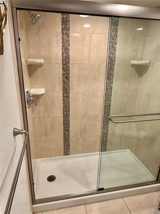 bathroom featuring a shower with shower door