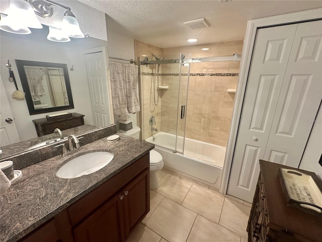 full bathroom featuring tile patterned floors, enclosed tub / shower combo, a textured ceiling, vanity, and toilet