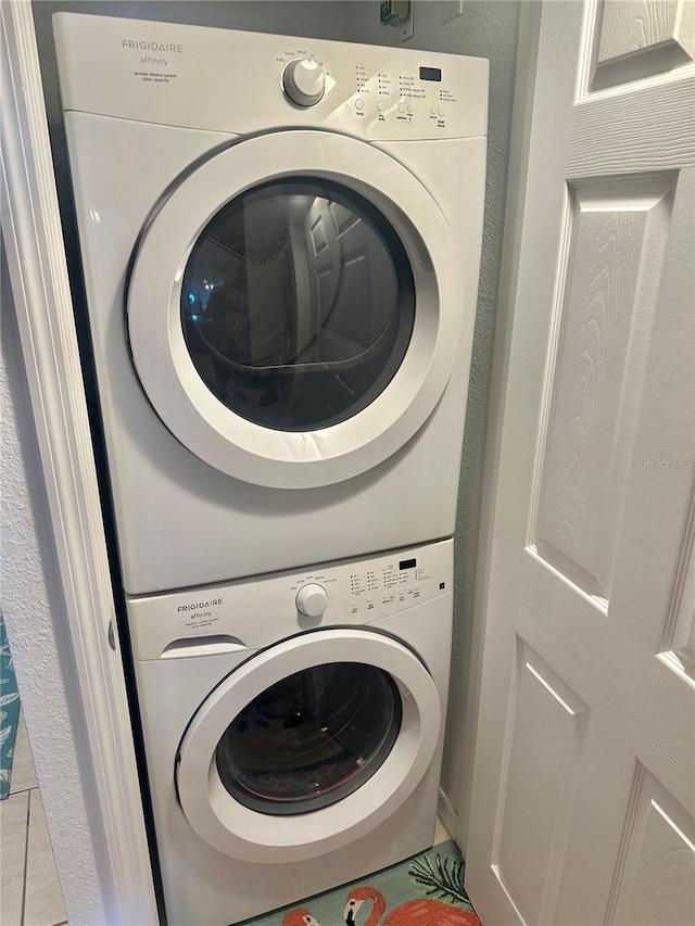 washroom featuring stacked washer and dryer