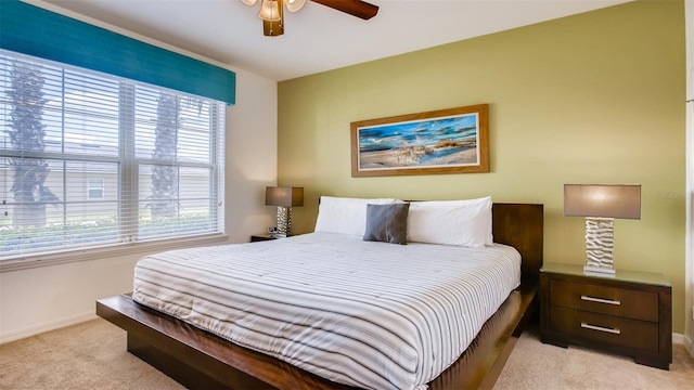 carpeted bedroom with ceiling fan and multiple windows