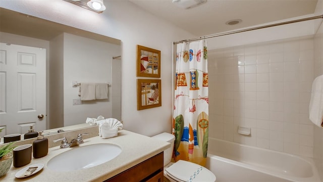 full bathroom with shower / tub combo with curtain, vanity, and toilet