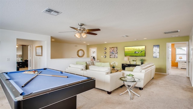 playroom with ceiling fan, a textured ceiling, pool table, and light carpet