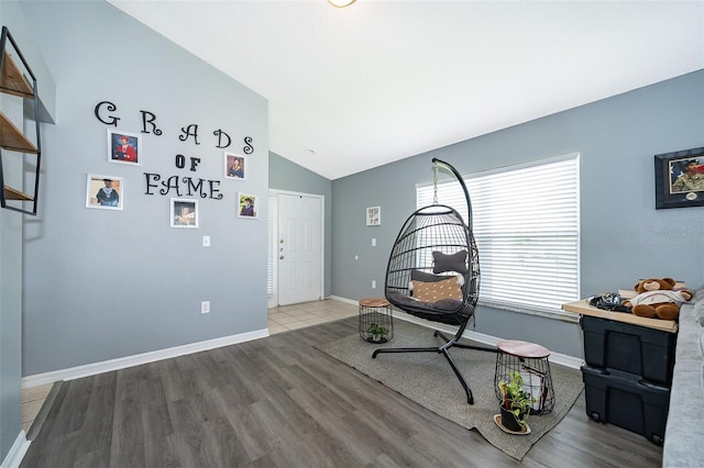 living area with wood-type flooring and lofted ceiling