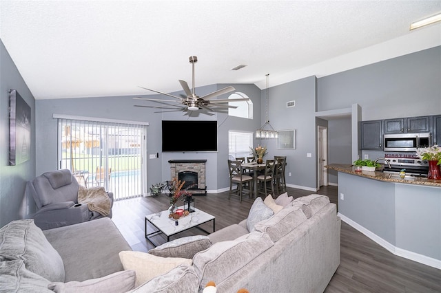 living room with ceiling fan, high vaulted ceiling, and dark hardwood / wood-style floors