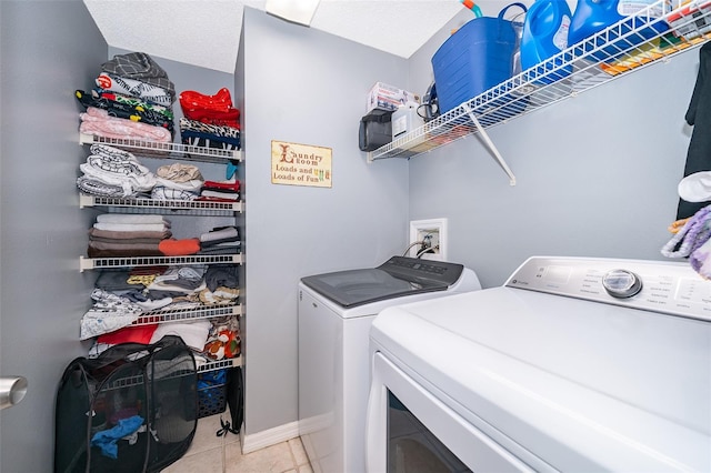 washroom with light tile patterned flooring and separate washer and dryer