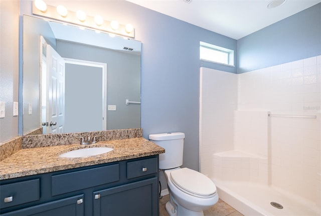 bathroom with a shower, tile patterned floors, toilet, and vanity