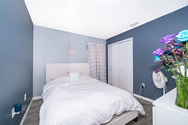 bedroom featuring a closet and dark hardwood / wood-style floors