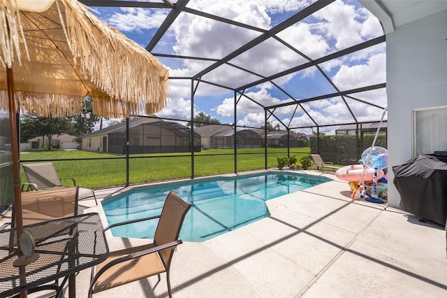 view of swimming pool with a lawn, a lanai, and a patio