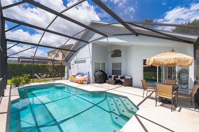 view of swimming pool with ceiling fan, an outdoor living space, a patio area, and a lanai