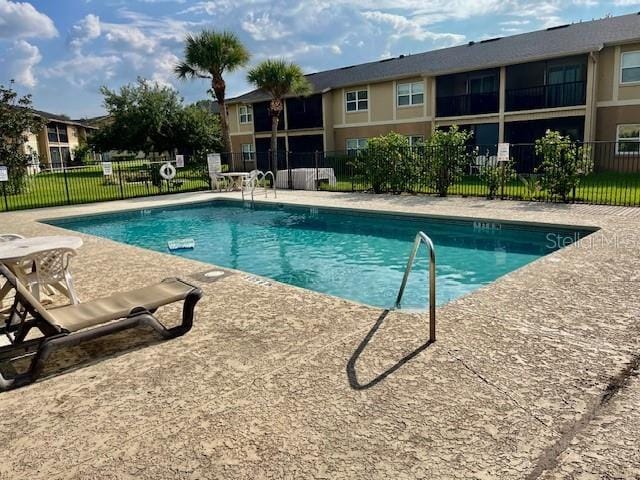 pool featuring a patio area and fence