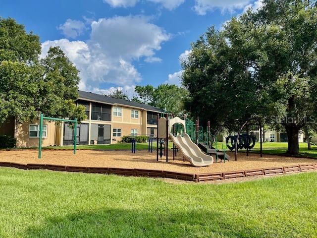 community play area featuring a lawn