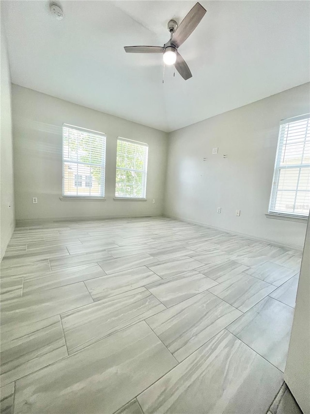 spare room featuring ceiling fan and light tile patterned floors