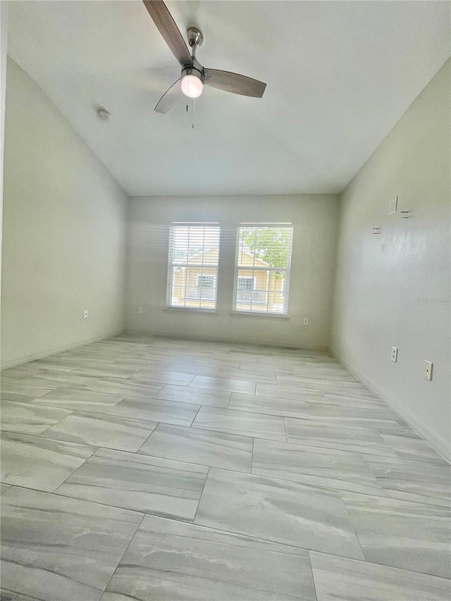 tiled empty room with ceiling fan