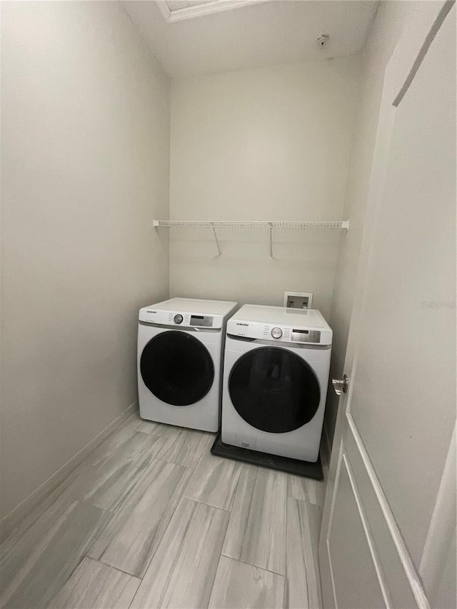 laundry area featuring washing machine and clothes dryer