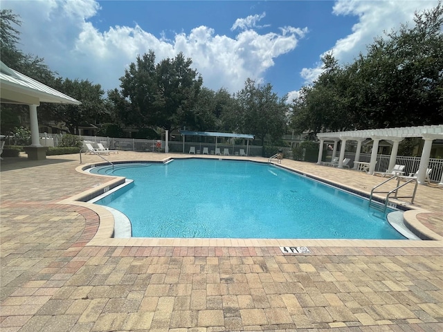 view of pool featuring a patio area and a pergola