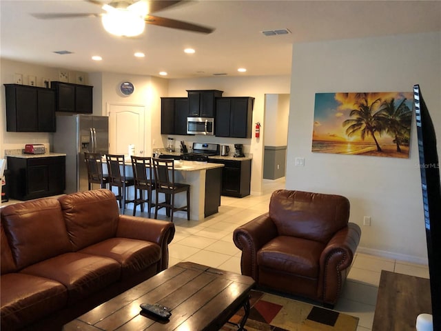5265 Oakbourne Ave, Davenport, FL 33837 - living room with ceiling fan, recessed lighting, and light tile patterned flooring
