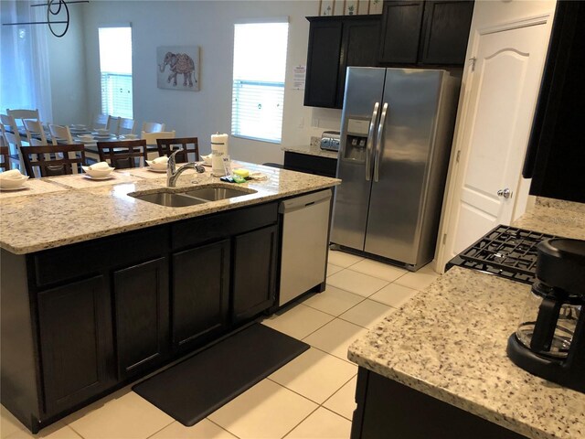 5265 Oakbourne Ave, Davenport, FL 33837 - kitchen with stainless steel appliances, a sink, plenty of natural light, and dark cabinets