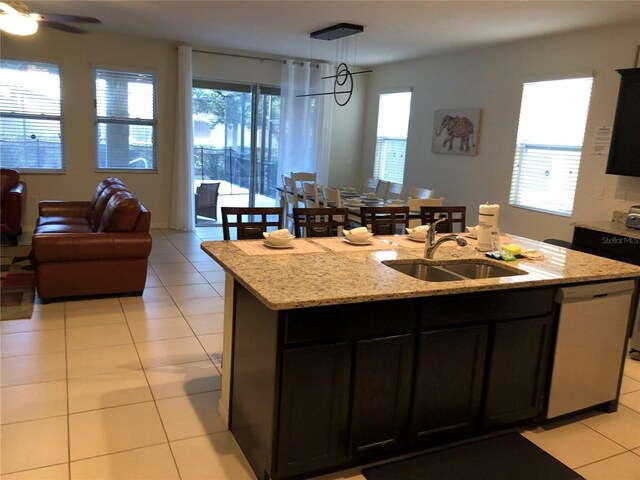 5265 Oakbourne Ave, Davenport, FL 33837 - kitchen featuring a sink, stainless steel dishwasher, open floor plan, a kitchen island with sink, and healthy amount of natural light