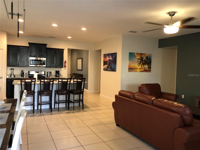 5265 Oakbourne Ave, Davenport, FL 33837 - living area with light tile patterned floors, recessed lighting, a ceiling fan, and baseboards