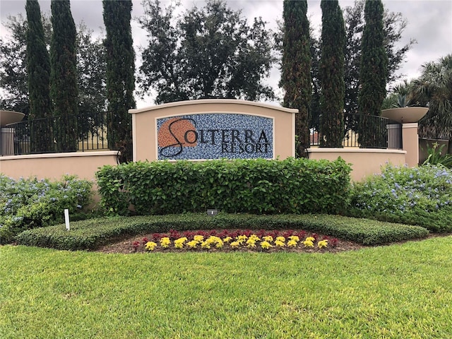 community sign featuring a lawn