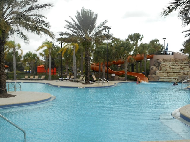 view of swimming pool with a water slide